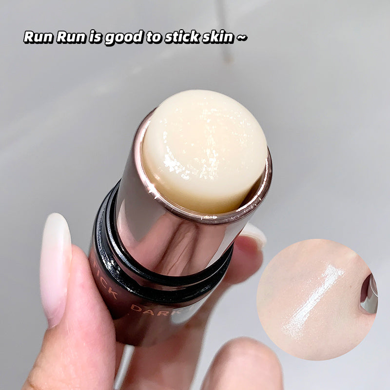 Lip balm being held with a gray background