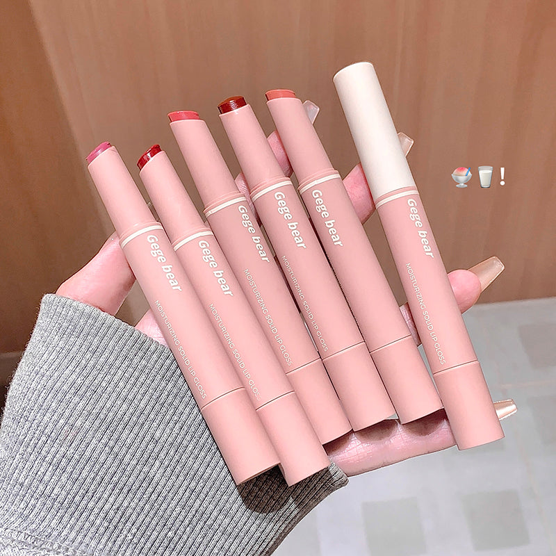 Set of pink lip products with 'Gee Bear' branding held by a hand against a neutral background.