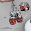 Two silver cat-shaped lip gloss pendants with red contents on a gray background.