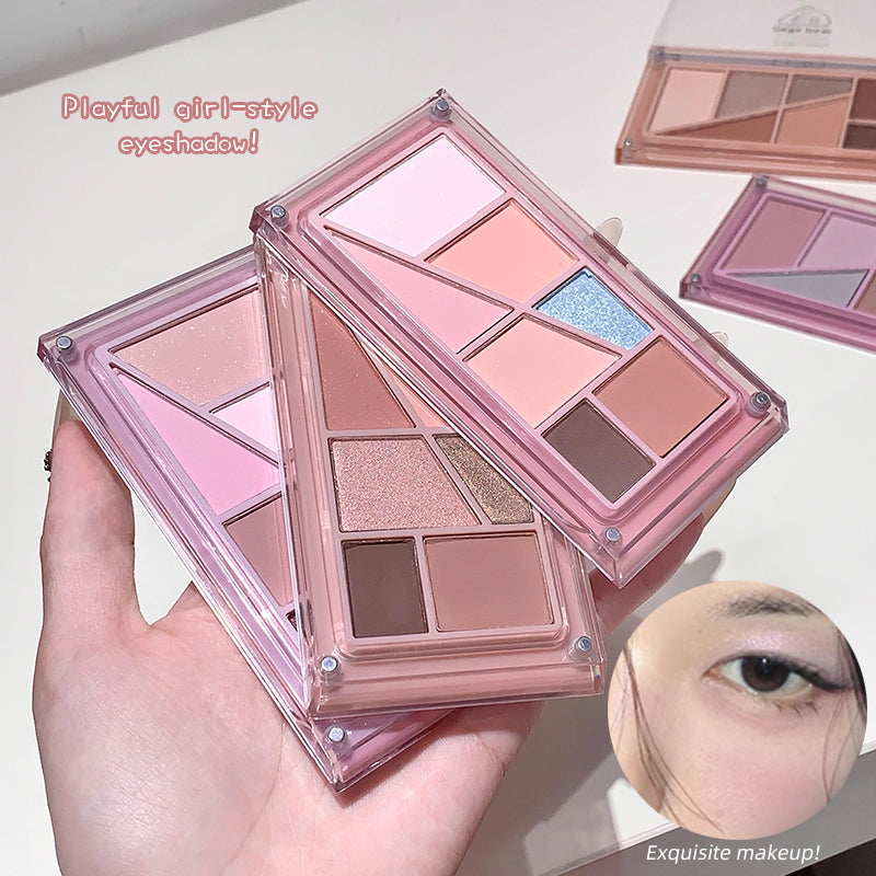 Makeup eyeshadow palette held by a hand with a close-up of an eye wearing the makeup.