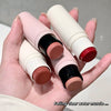 Hand holding three lip balms with visible color swatches on a neutral background