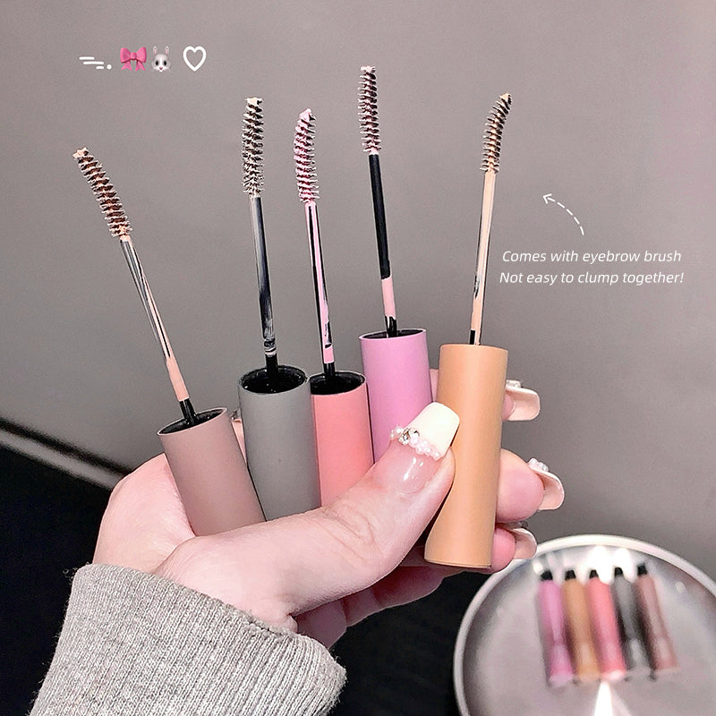Set of makeup brushes with handles in various colors held by a hand.