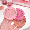 Three blush compact cases from the brand 'GE BEAR' held by a hand on a light pink background.