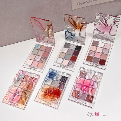 Set of makeup palettes with colorful shades on a white surface