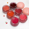 Set of lip balm jars with various colors on a white background