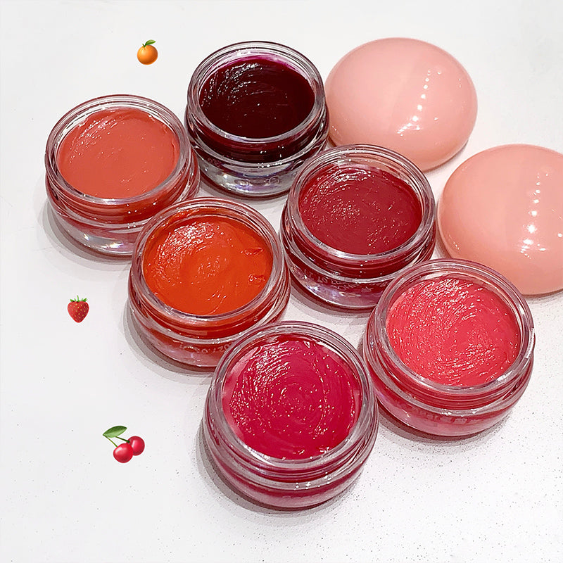 Set of lip balm jars with various colors on a white background