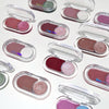 Collection of small makeup compact cases with colorful shades on a white background