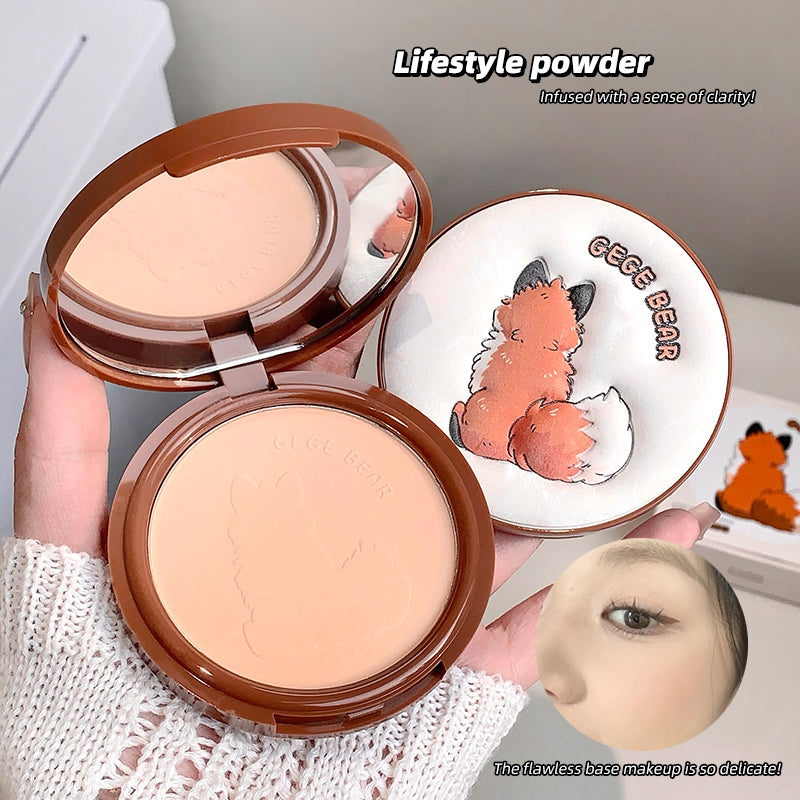 Compact powder with a cartoon bear design on the case, held by a person.