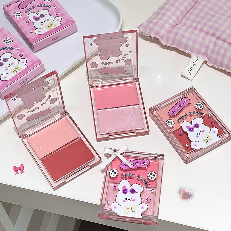 Pink makeup products with cartoon character packaging on a white surface