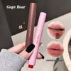 Two lip products held by a hand with a blurred background, featuring 'Gege Bear' branding.