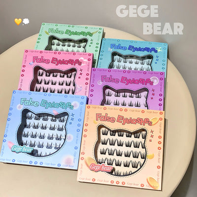 Five boxes of false eyelashes with colorful packaging on a beige surface, featuring the brand 'GEGE BEAR'.