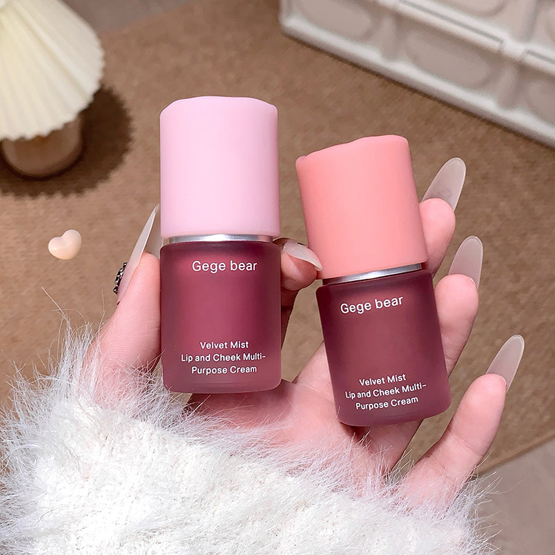 Two Gege bear cosmetic bottles held in a hand with a soft background