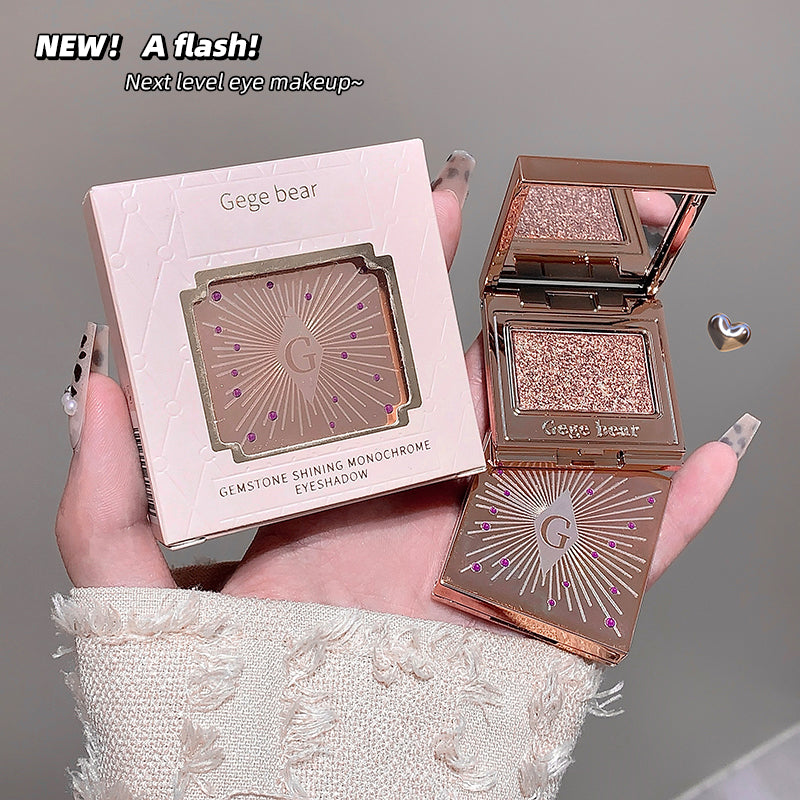 Gege bear gemstone shining monochrome eyeshadow compact held by a hand with a gray background