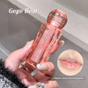 Hand holding a pink Gege Bear lip gloss with a close-up of lips wearing the product.