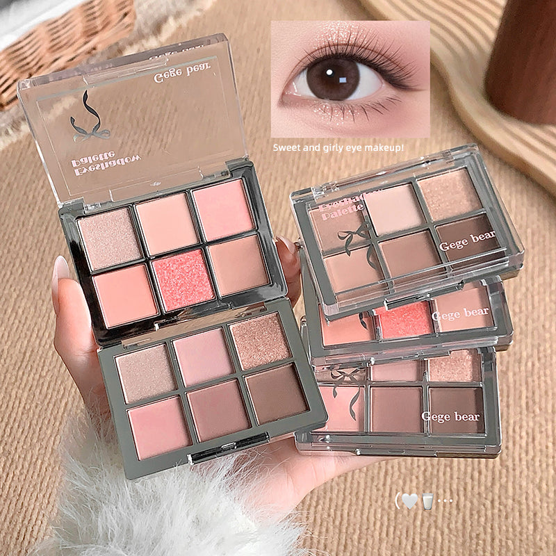 Makeup palette with pink and brown shades held by a hand, with an inset of eye makeup application.