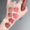 Hand with lipstick swatches on a gray background