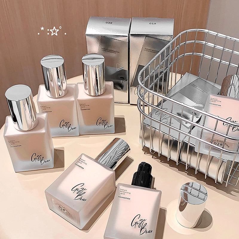 Cosmetic products with silver lids on a beige surface, featuring a wire basket.