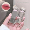 Hand holding a silver and pink lip gloss with close-up of lips and product.