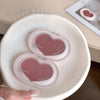 Heart-shaped pink powder puffs in a white container with 'Gege bear' branding.