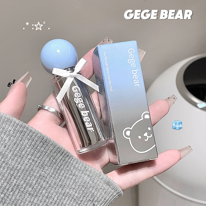 Hand holding a 'GEGE BEAR' lip balm with its packaging against a neutral background.