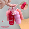 Pink and red blush sticks with floral design, held by a hand against a neutral background.
