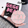 Hand holding a Gege Bear product with packaging in the background