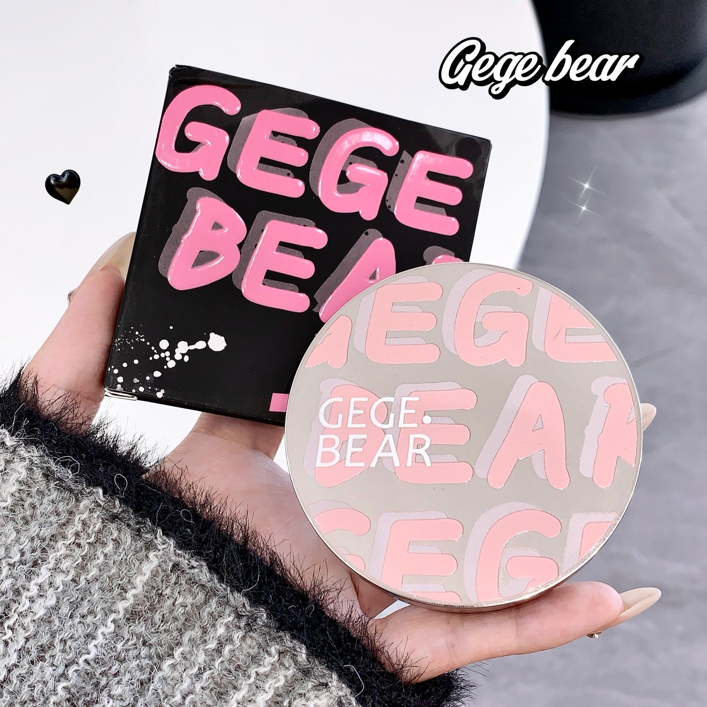 Hand holding a Gege Bear product with packaging in the background