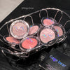 Set of blushes in clear cases with 'Gege bear' branding on a dark surface.
