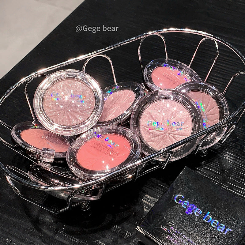 Set of blushes in clear cases with 'Gege bear' branding on a dark surface.