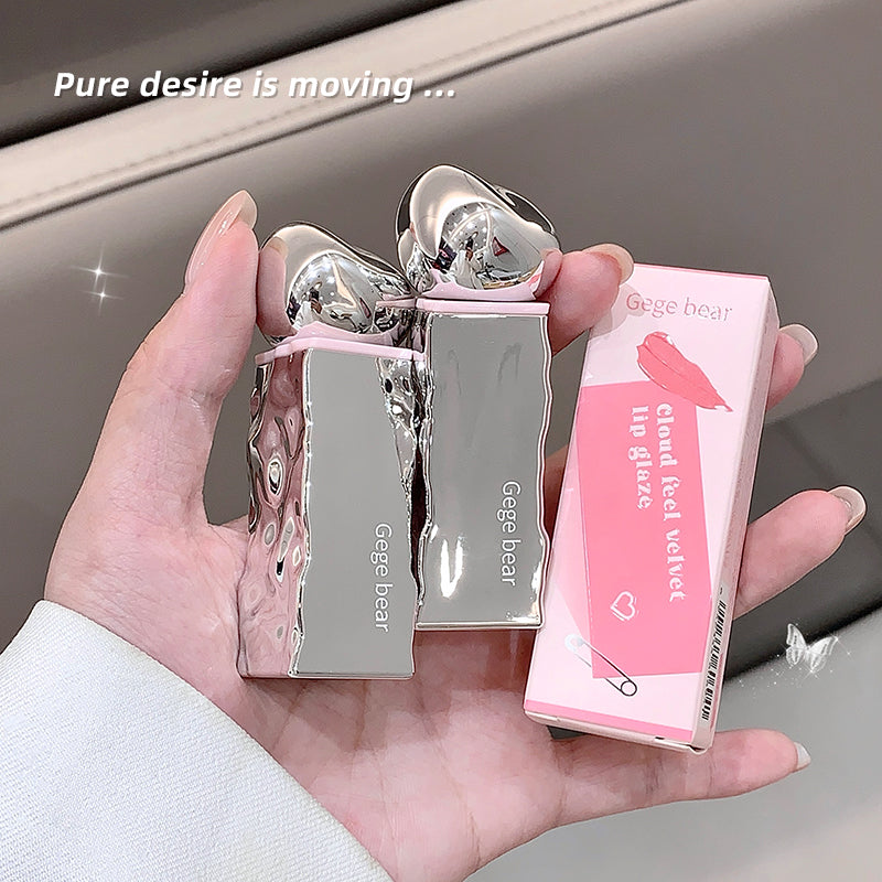 Hand holding two silver lip glosses and a pink box with 'Gege bear' branding.