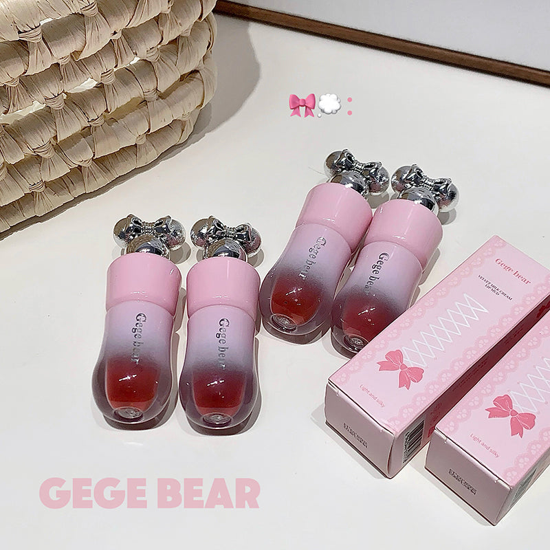 Pink and red gradient lip gloss with packaging on a light surface, featuring the brand 'GEGE BEAR'.