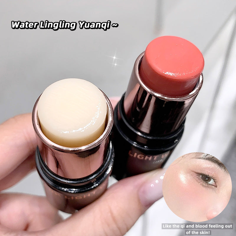 Two lip balms held by a hand with a close-up of a lip, on a light gray background.