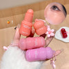 Three pink blush sticks with 'Geege bear' branding held by a hand against a wooden background.