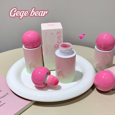 Pink cosmetic set with 'Gege bear' branding on a white plate.