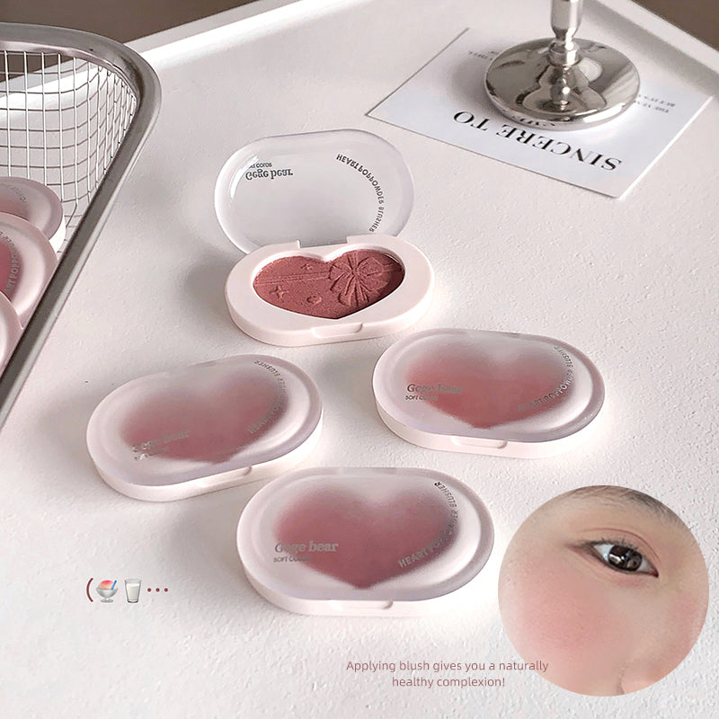 Makeup products including blushes in open and closed cases on a white surface with an eye close-up and text overlay.