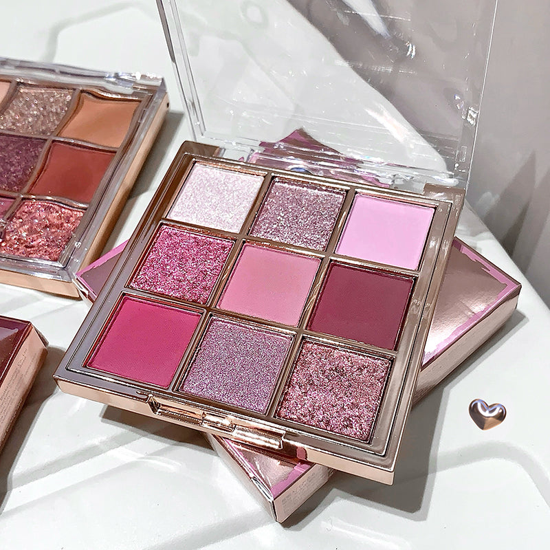 Makeup palette with pink and purple shades on a white background