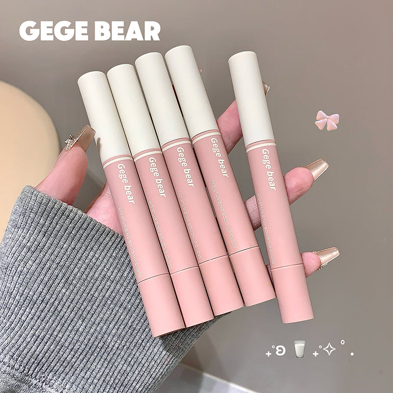 Set of pink 'GEGE BEAR' lip products held by a hand with gray sleeve.