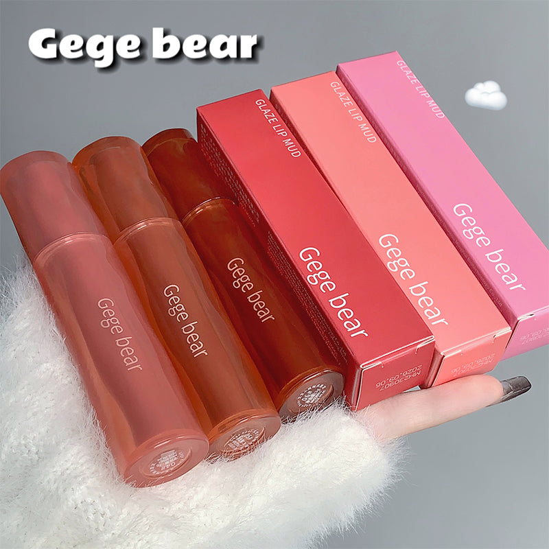 Gege bear lip gloss and packaging on a gray background