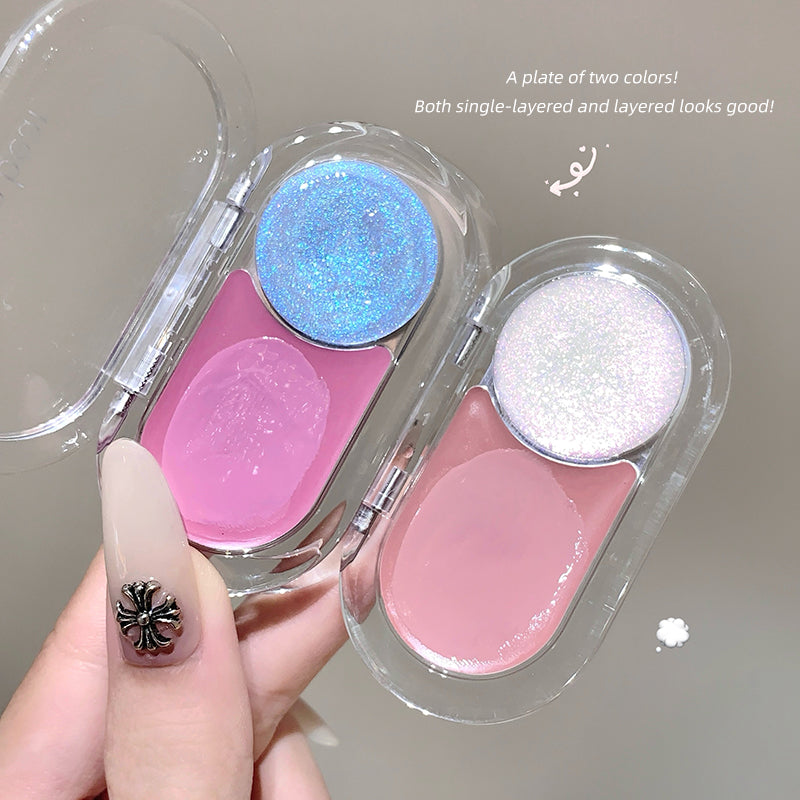 Two glittery makeup products in a clear case held by a hand.