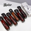 Set of Gege bear lip glosses with packaging on a white background