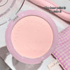 Pink compact powder with bear print design on a light background