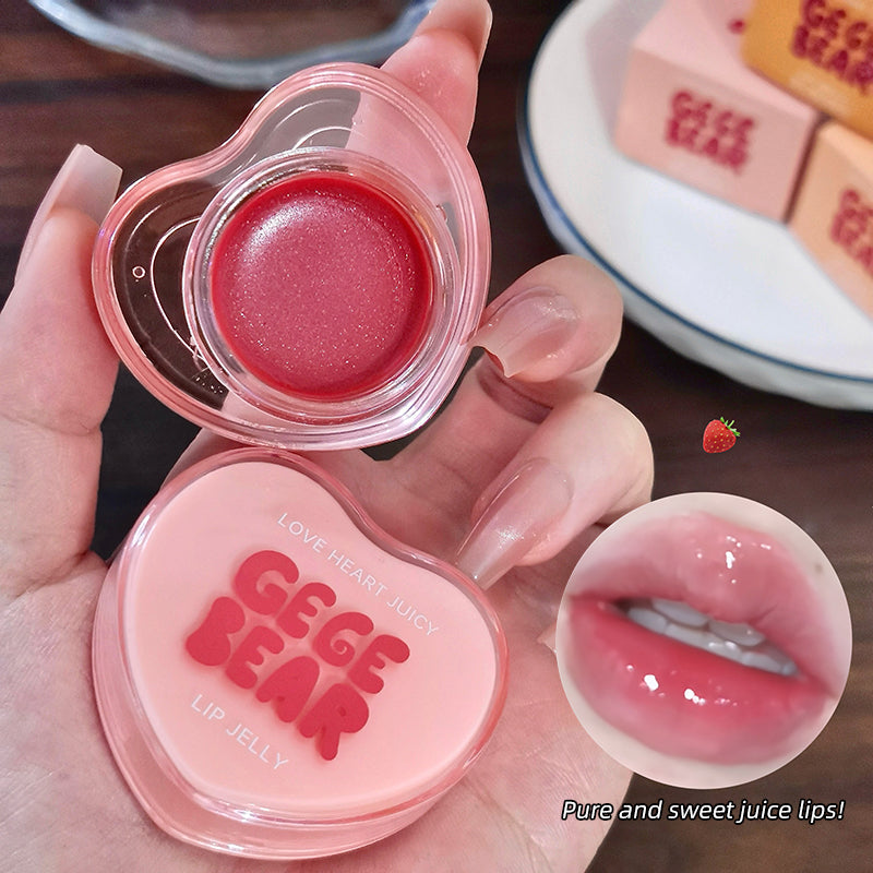 Heart-shaped GEGE BEAR lip jelly with a strawberry illustration on a wooden surface.