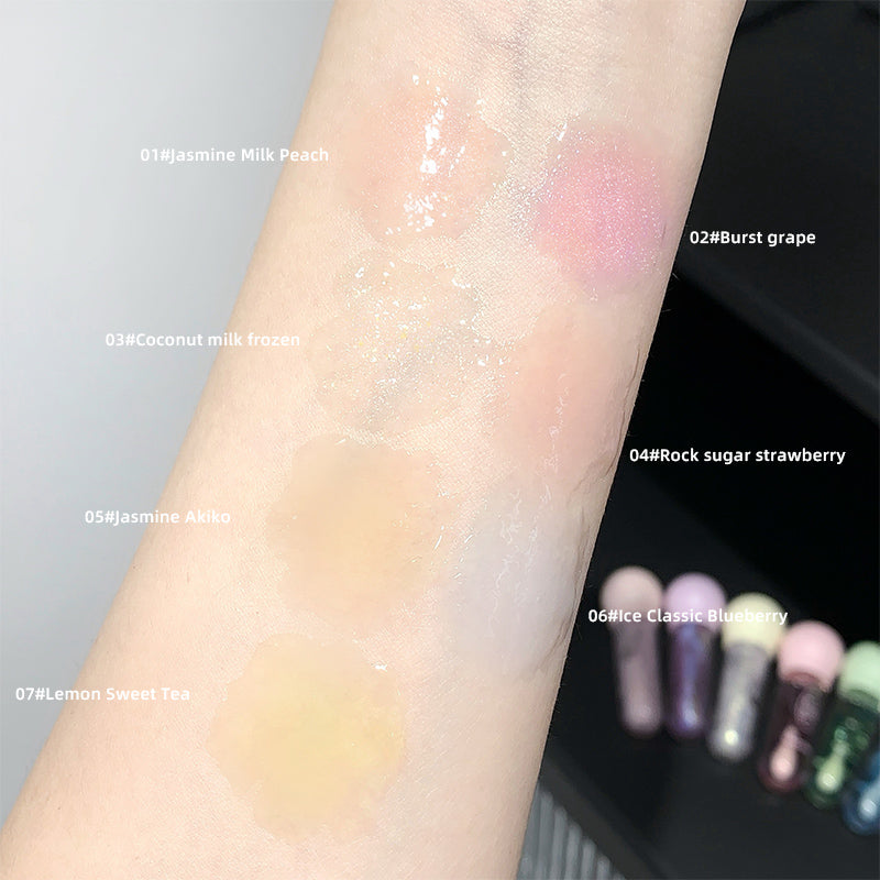 Color swatches on a wrist with labeled shades of lip gloss.
