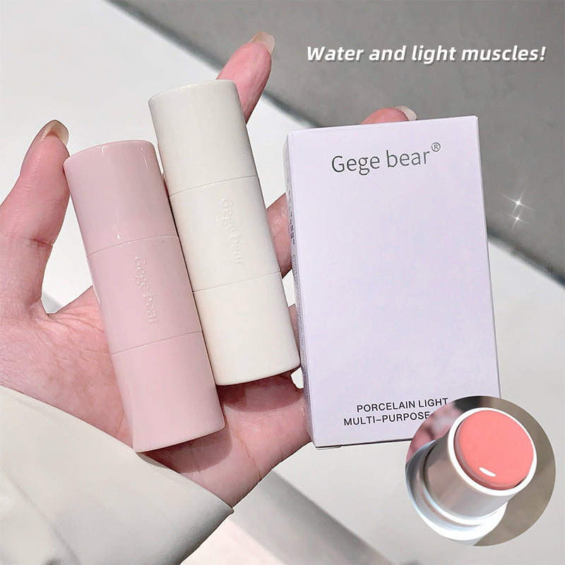 Hand holding two cosmetic tubes and a box labeled 'Gege bear' on a light background.