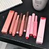 Set of lip products including lipsticks and lip glosses on a dark surface with 'Gege bear' branding.