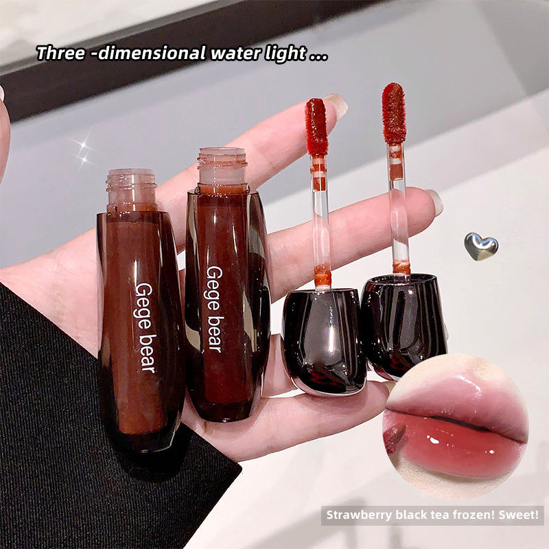 Lip gloss with 'Gege bear' branding held in a hand, showing a close-up of lips with the product.