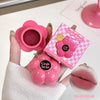 Pink flower-shaped makeup product with 'Gege bear' branding, held by a hand.