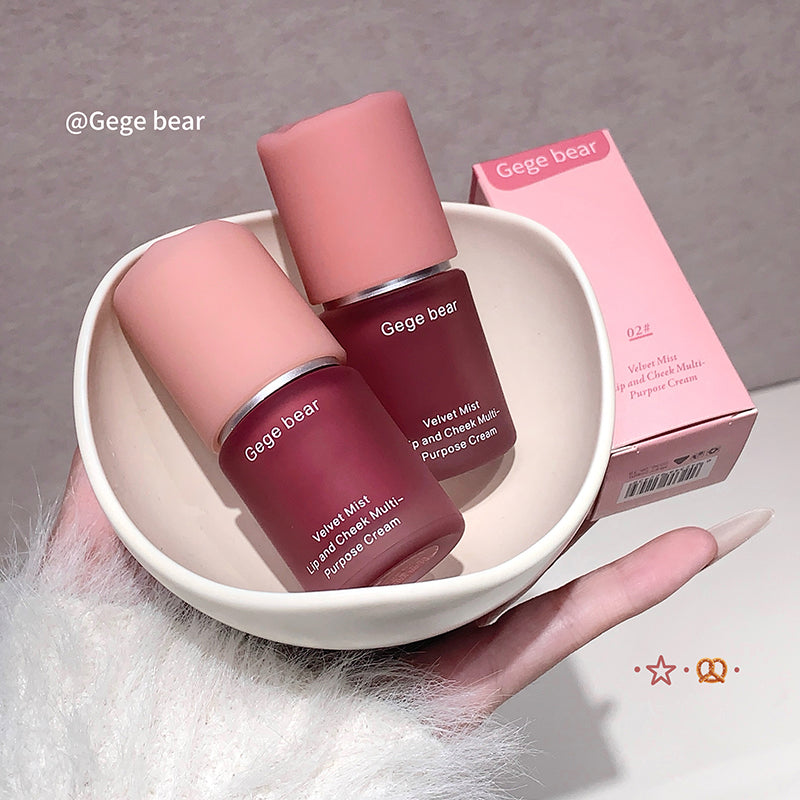 Two Gege bear lip and cheek multi-purpose creams in a white dish with a pink box in the background.