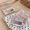 Makeup palettes with eyeshadow shades on a textured surface