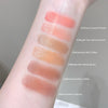 Lip color swatches on a person's arm with labeled shades.